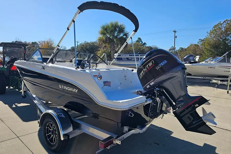 Slide: The Image of 2026 Stingray 172 DC boat with Yamaha engine, parked outdoors on a sunny day. - 7