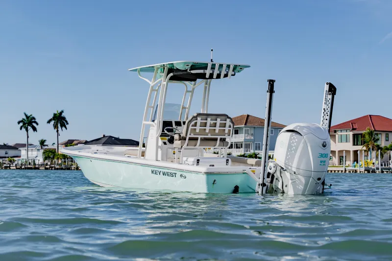The Image of 2024 Key West 250 Bay Reef boat on water near waterfront homes. - 1