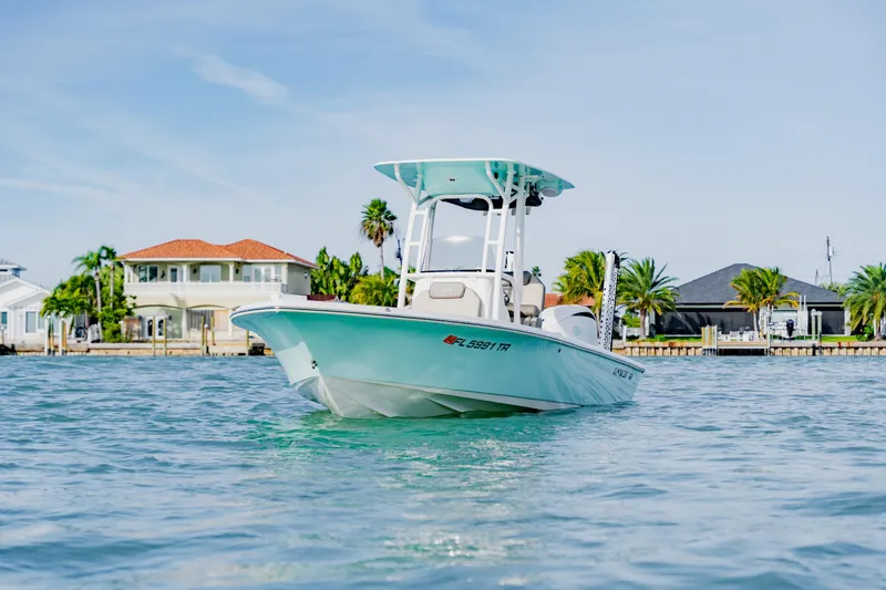 Slide: The Image of 2024 Key West 250 Bay Reef boat on water near waterfront homes. - 13