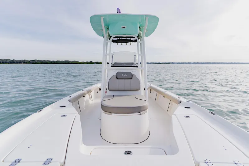 Slide: The Image of 2024 Key West 250 Bay Reef boat on calm water, showcasing sleek design and spacious deck. - 18