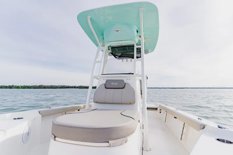 Slide: The Image of 2024 Key West 250 Bay Reef boat on calm water, featuring a sleek design and comfortable seating. - 19