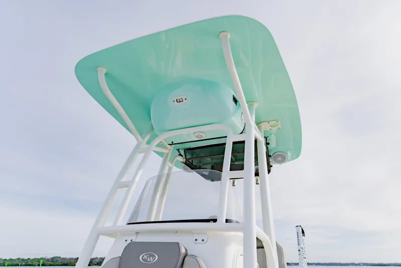 Slide: The Image of 2024 Key West 250 Bay Reef boat with teal T-top and white frame. - 21