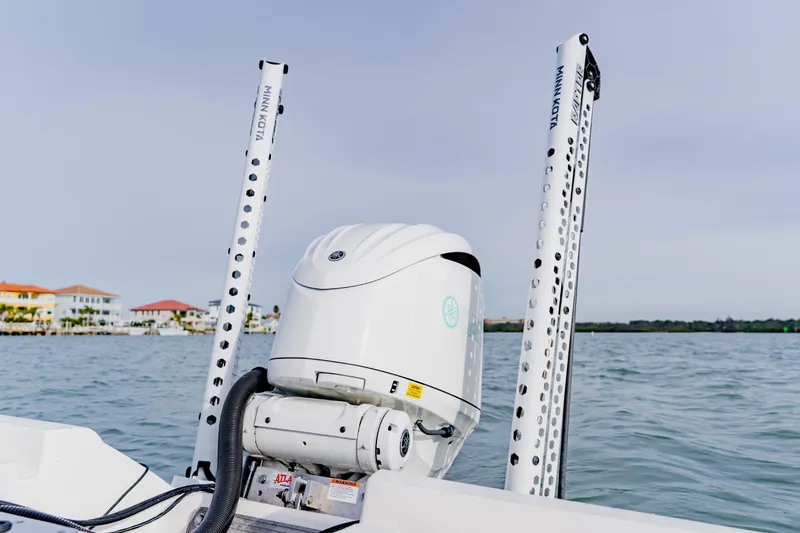 Slide: The Image of 2024 Key West 250 Bay Reef boat with Minn Kota trolling motor on water. - 29