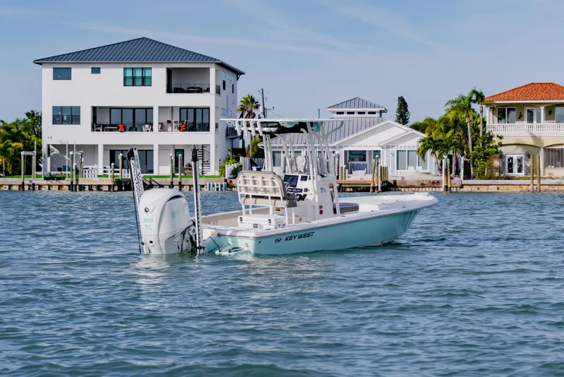 Slide: The Image of 2024 Key West 250 Bay Reef boat on water near waterfront homes. - 3