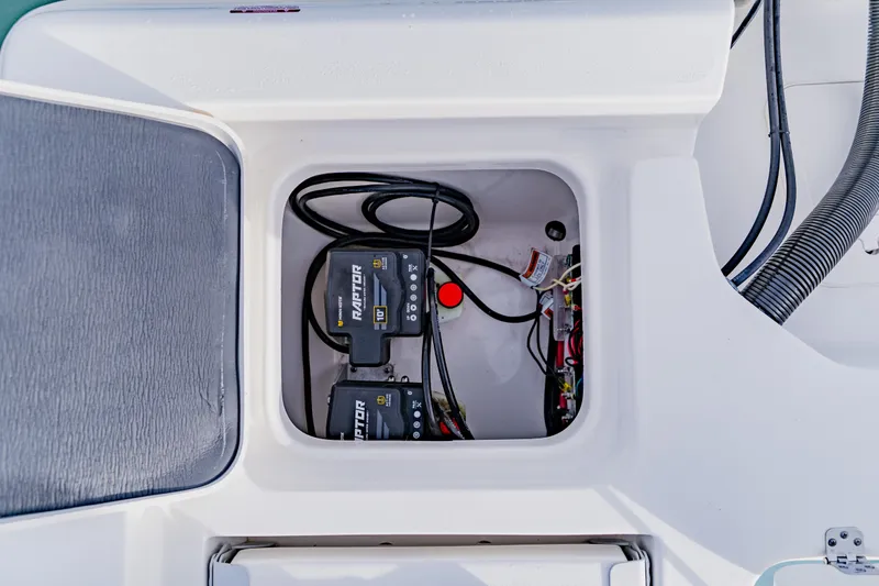 Slide: The Image of 2024 Key West 250 Bay Reef boat battery compartment with wiring and components. - 31
