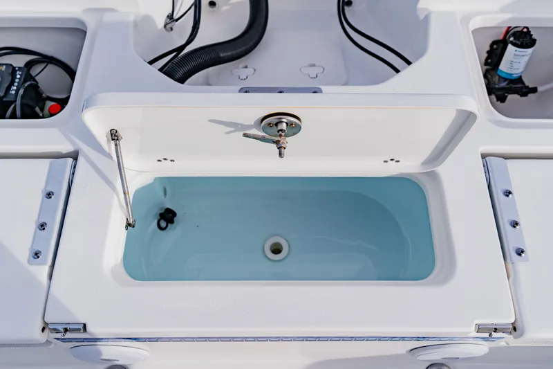 Slide: The Image of 2024 Key West 250 Bay Reef boat livewell with open lid and visible water. - 33