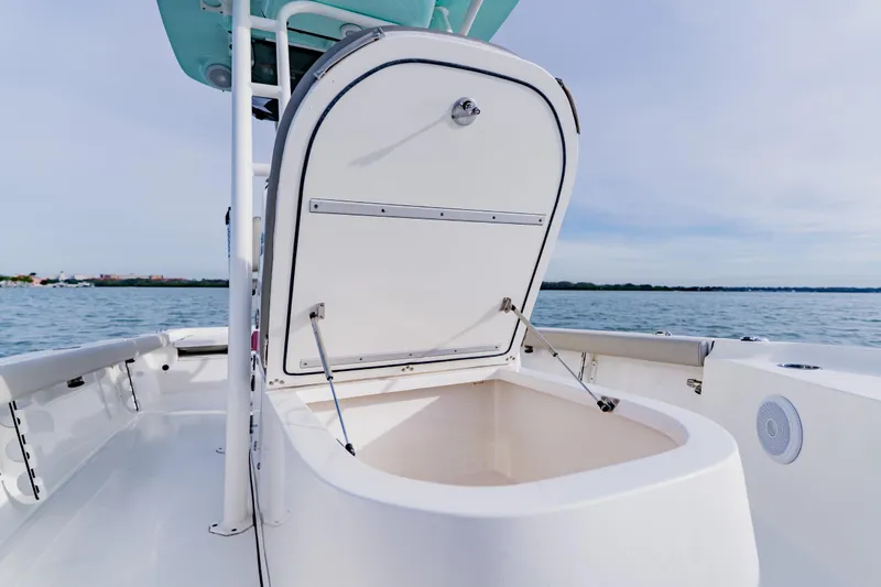 Slide: The Image of 2024 Key West 250 Bay Reef boat with open storage compartment on calm water. - 35