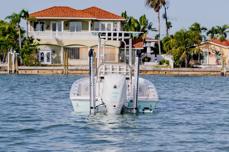 Slide: The Image of 2024 Key West 250 Bay Reef boat on water near waterfront homes. - 4