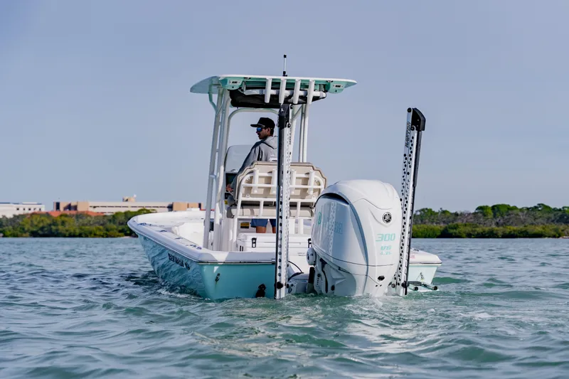 Slide: The Image of 2024 Key West 250 Bay Reef boat cruising on water with outboard motor. - 6