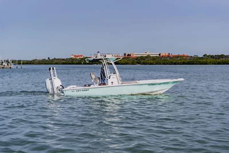 Slide: The Image of 2024 Key West 250 Bay Reef boat cruising on calm waters. - 9