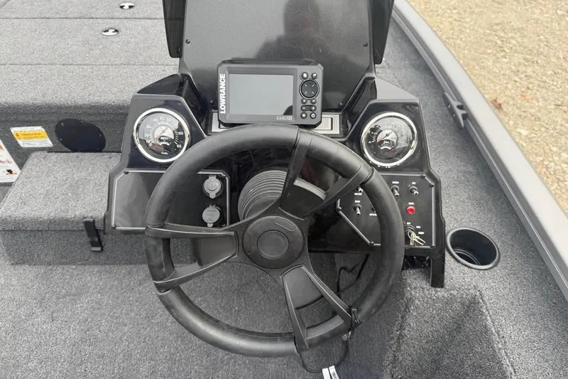 Slide: The Image of 2026 Lowe Stinger 175C boat dashboard with steering wheel and Lowrance electronics. - 9