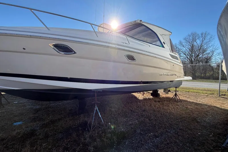 The Image of 2017 Regal 35 Sport Coupe boat on stands, sunlit, outdoors. - 0