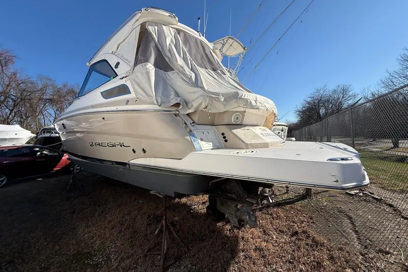 Slide: The Image of 2017 Regal 35 Sport Coupe boat in storage, covered, with clear blue sky. - 1