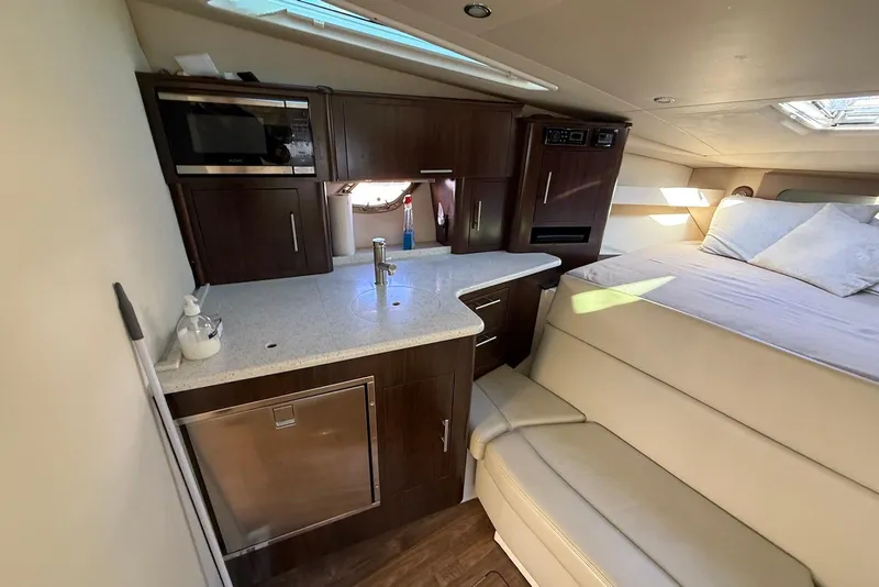 Slide: The Image of Interior of 2017 Regal 35 Sport Coupe with kitchenette and cozy sleeping area. - 10