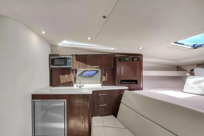 Slide: The Image of Interior of 2017 Regal 35 Sport Coupe yacht with kitchenette and seating area. - 4