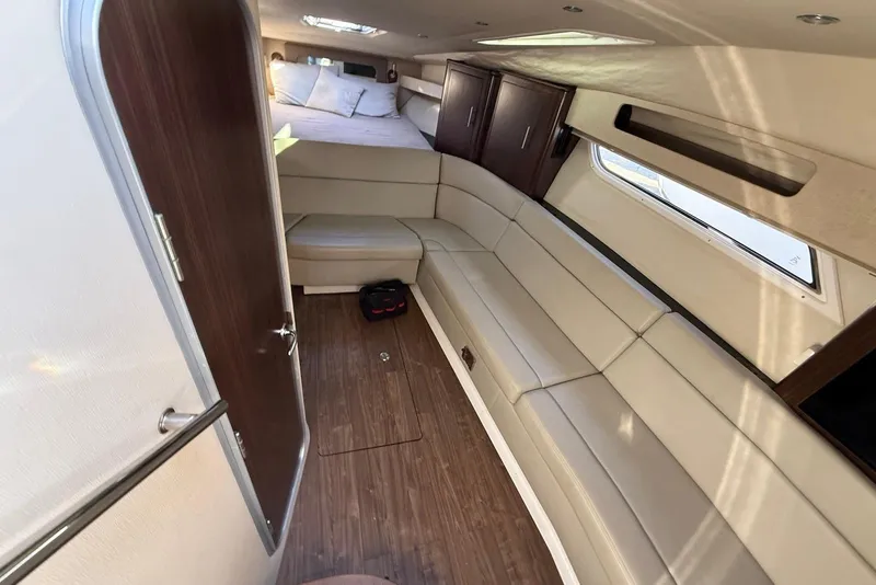 Slide: The Image of Interior of 2017 Regal 35 Sport Coupe with beige seating and wood accents. - 9