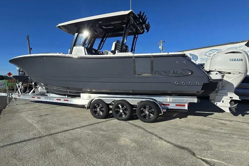 The Image of 2026 Robalo R300 Center Console boat on trailer with Yamaha engines. - 0
