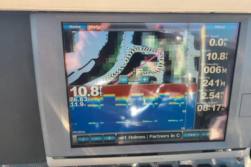 Slide: The Image of Garmin marine GPS display on 2002 Scout 280 Sportfish, showing navigation and depth data. - 11