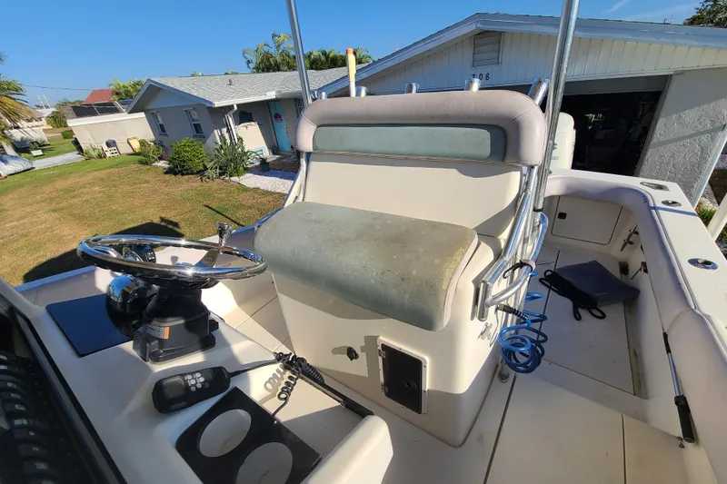 Slide: The Image of 2002 Scout 280 Sportfish boat interior with steering wheel and seating area. - 13
