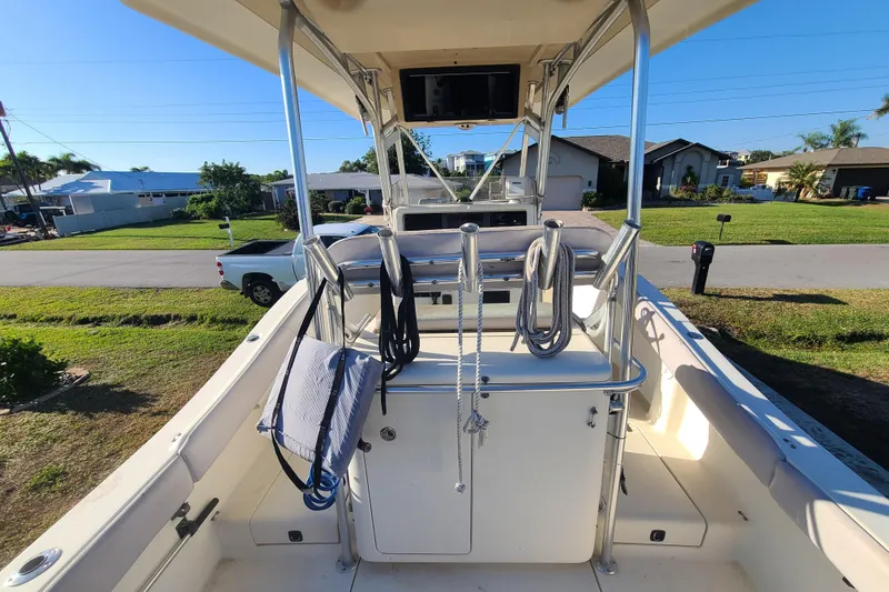 Slide: The Image of 2002 Scout 280 Sportfish boat interior with ropes and equipment, parked in a residential area. - 15