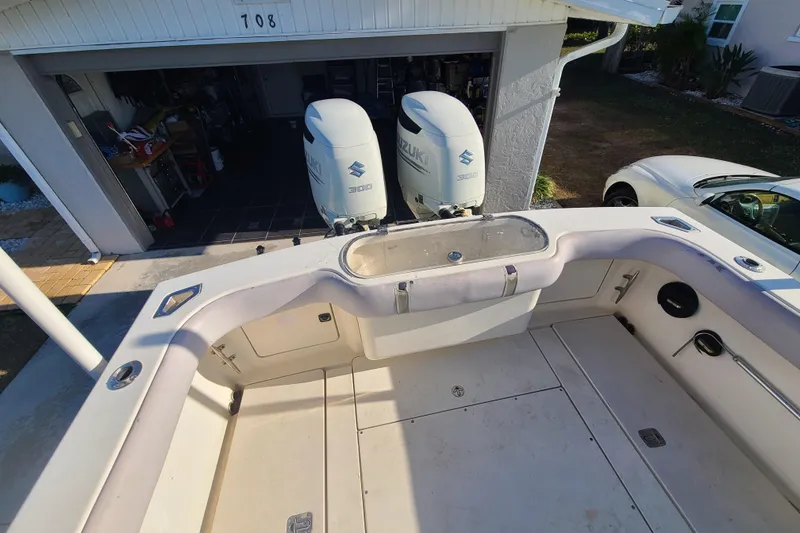 Slide: The Image of 2002 Scout 280 Sportfish boat with dual Suzuki 300 engines in a driveway. - 18