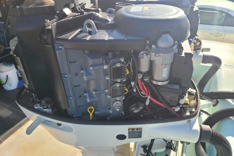 Slide: The Image of Open engine of a 2002 Scout 280 Sportfish boat, showcasing internal components. - 22