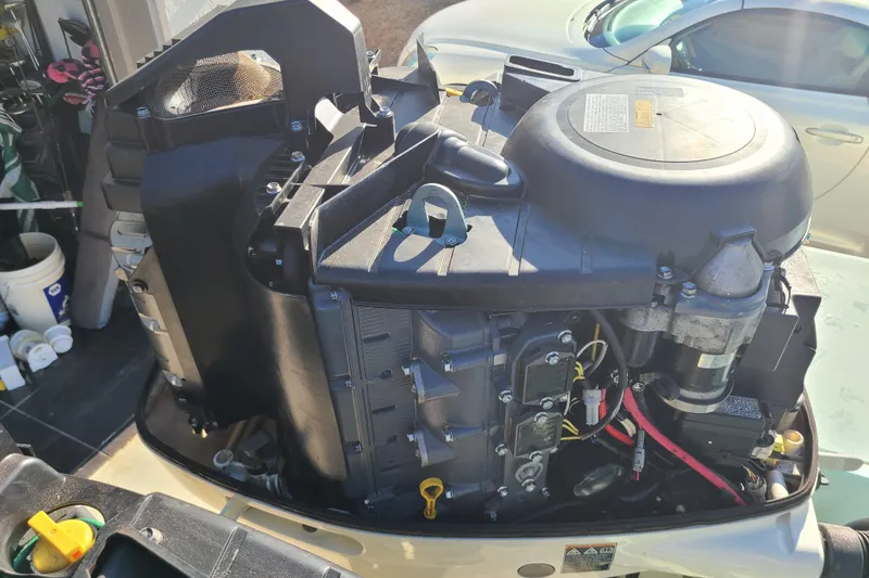 Slide: The Image of 2002 Scout 280 Sportfish engine, detailed view in a garage setting. - 24