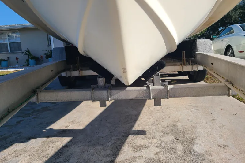 Slide: The Image of 2002 Scout 280 Sportfish boat on trailer, parked in driveway. - 27