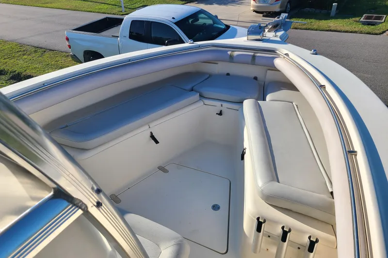 Slide: The Image of 2002 Scout 280 Sportfish boat interior with cushioned seating and rod holders. - 4