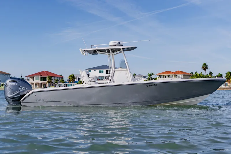 Slide: The Image of 2023 Pathfinder 2700 Open boat on water, with Yamaha engine, coastal homes in background. - 12