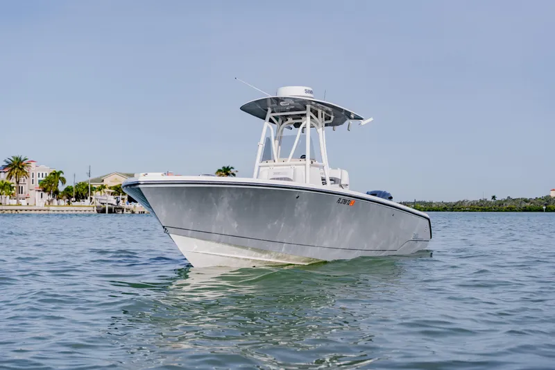 Slide: The Image of 2023 Pathfinder 2700 Open boat on calm water near coastal homes. - 14