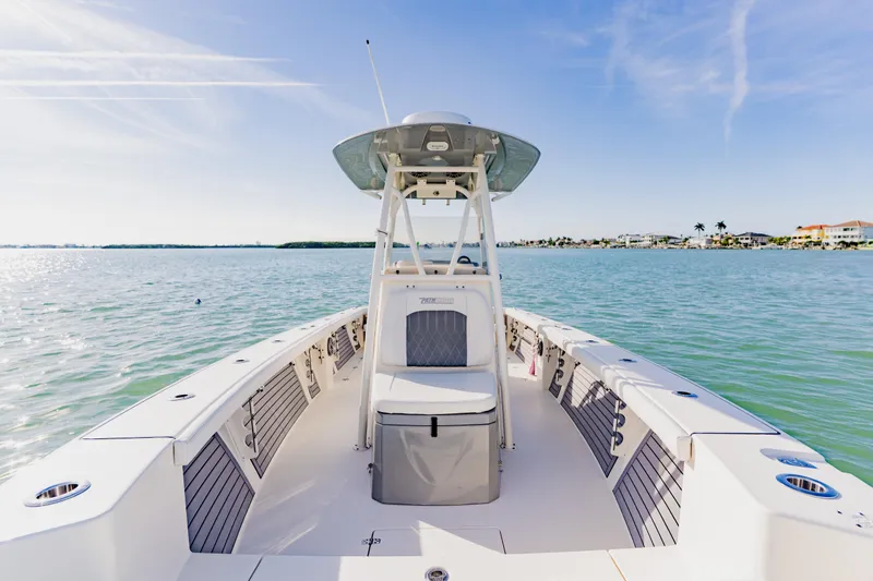 Slide: The Image of 2023 Pathfinder 2700 Open boat on calm water, clear sky, coastal view. - 17