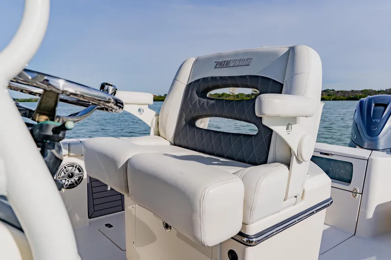 Slide: The Image of 2023 Pathfinder 2700 Open boat interior with cushioned seating and steering wheel. - 20