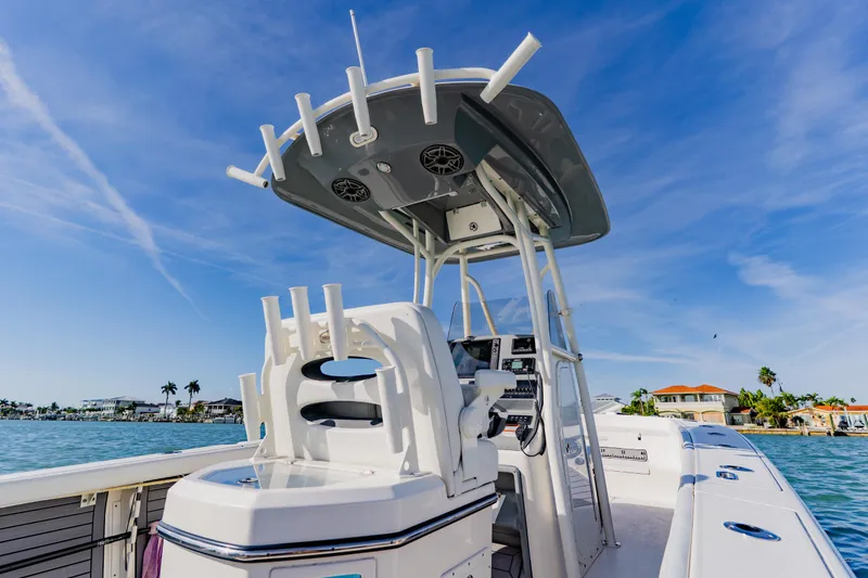 Slide: The Image of 2023 Pathfinder 2700 Open boat on water, clear sky, luxury waterfront homes in background. - 22