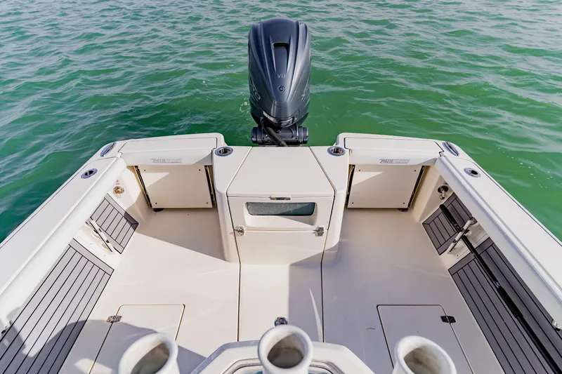 Slide: The Image of 2023 Pathfinder 2700 Open boat deck with outboard motor on water. - 24