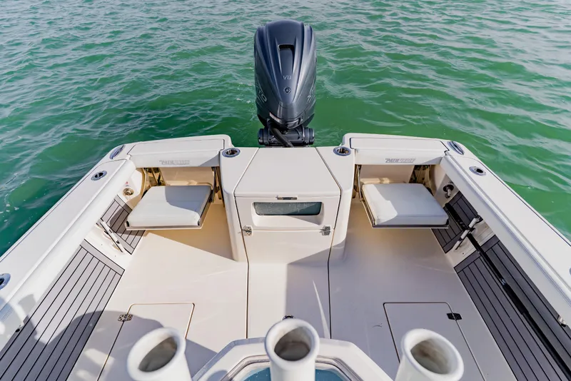 Slide: The Image of 2023 Pathfinder 2700 Open boat interior with seating and outboard motor on water. - 25