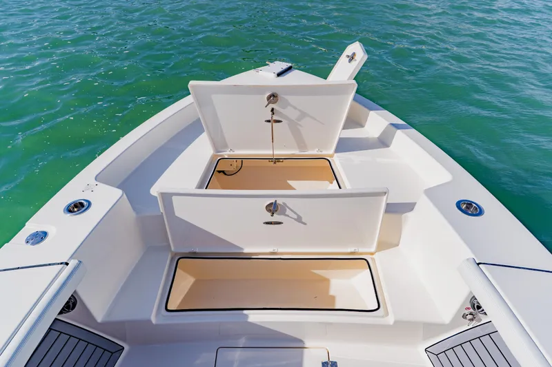 Slide: The Image of 2023 Pathfinder 2700 Open boat with open storage compartments on calm water. - 29