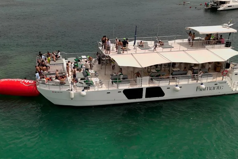 Slide: The Image of Aerial view of a 2027 Custom PAXCAT boat hosting a lively party on the water. - 1