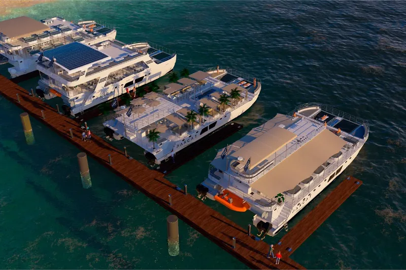 Slide: The Image of Luxury yachts docked at a marina, featuring the 2027 Custom PAXCAT model. - 12