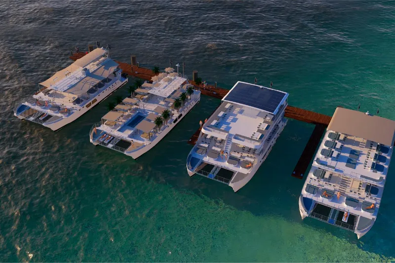 Slide: The Image of Four luxury catamarans docked at a pier, Custom PAXCAT model, 2027. - 15