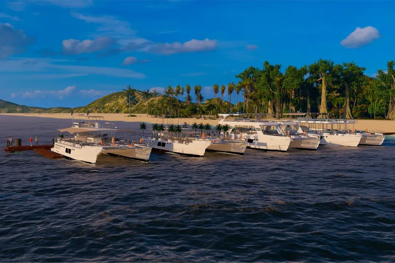 Slide: The Image of Custom PAXCAT 2027 catamarans docked at tropical island with lush greenery. - 18