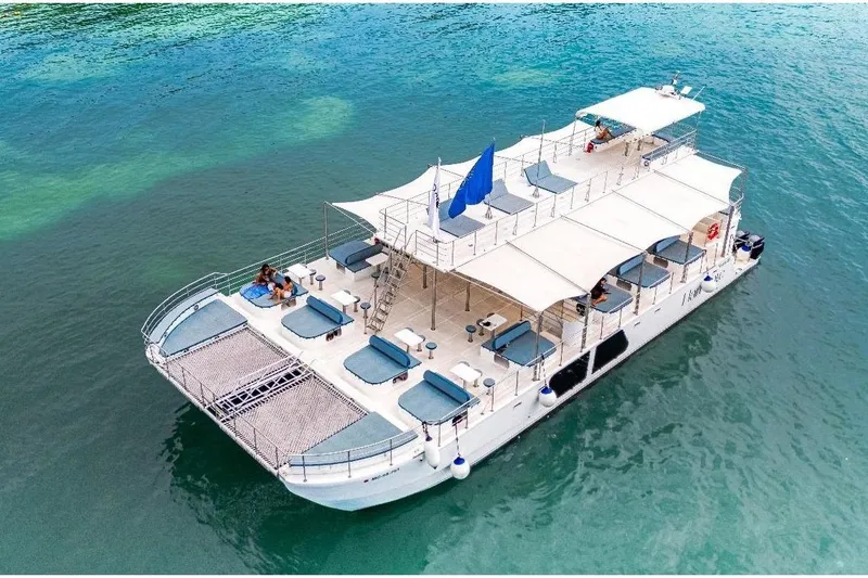 Slide: The Image of Custom PAXCAT 2027 catamaran with sunbathing decks on turquoise water. - 3