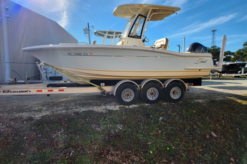 The Image of 2024 Scout 215 XSF boat displayed indoors with Yamaha engine. - 0