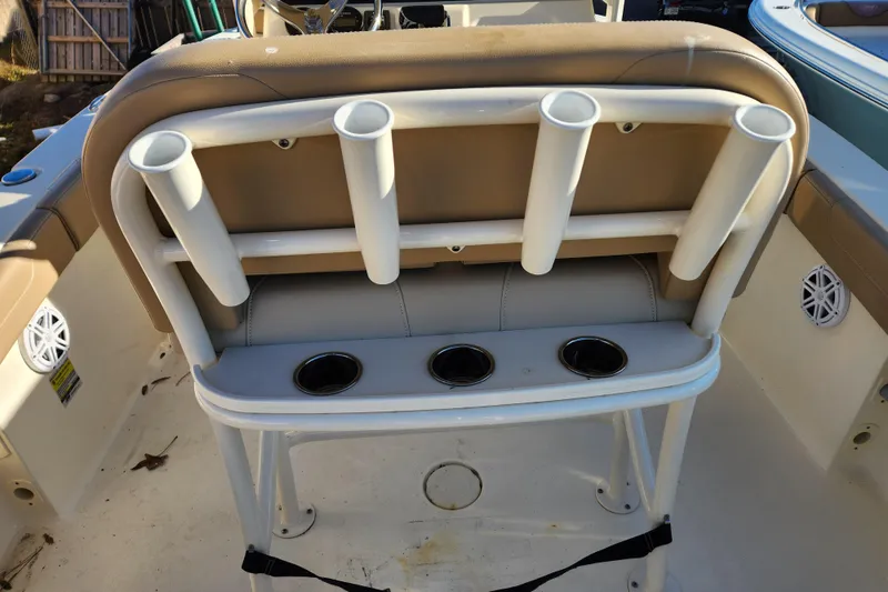 Slide: The Image of 2024 Scout 215 XSF boat interior with steering console and rod holders. - 13