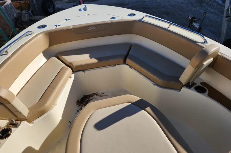 Slide: The Image of 2024 Scout 215 XSF boat interior with beige seating and sleek design. - 14