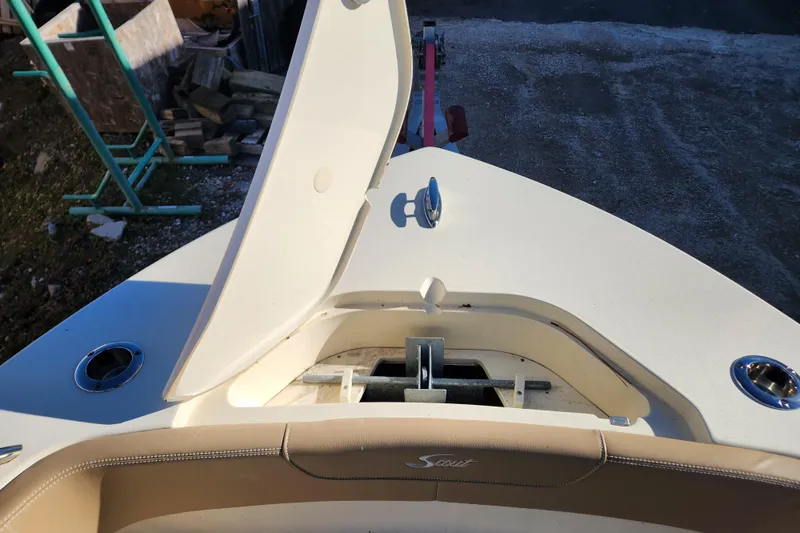 Slide: The Image of 2024 Scout 215 XSF boat interior with beige seating and steering wheel. - 16