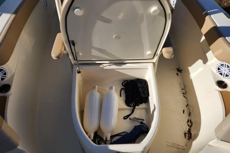 Slide: The Image of 2024 Scout 215 XSF boat interior with beige seating and modern design. - 17