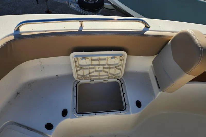 Slide: The Image of 2024 Scout 215 XSF boat interior with fish box cooler storage open. - 18