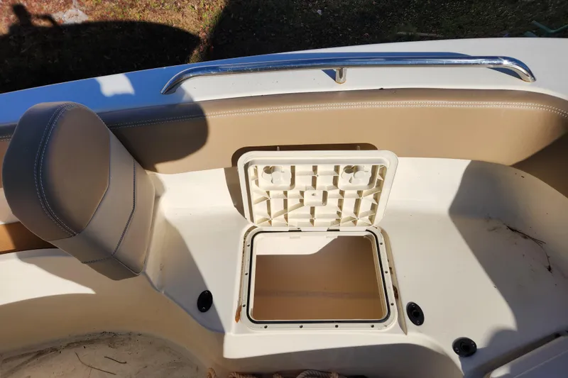 Slide: The Image of 2024 Scout 215 XSF boat interior with beige seating and cup holders. - 19