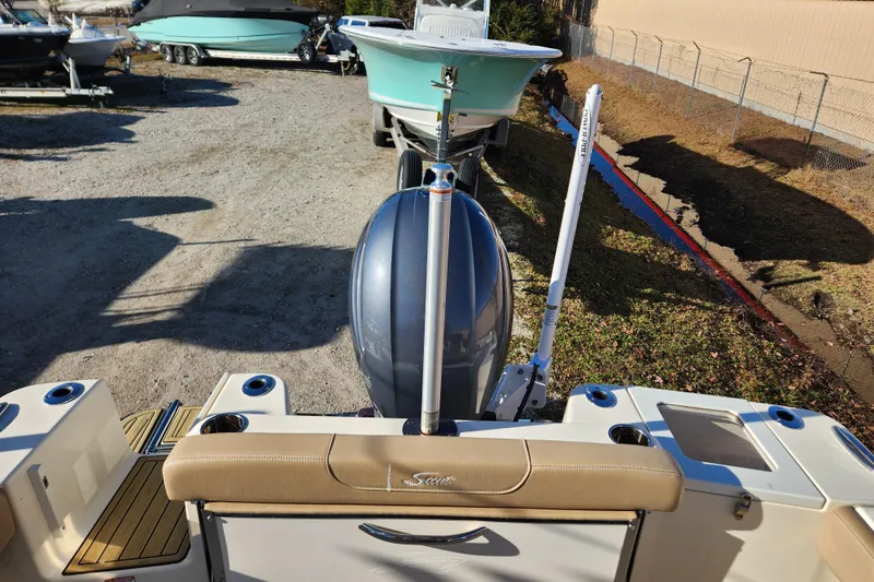 Slide: The Image of 2024 Scout 215 XSF boat interior with open storage compartments and beige seating. - 21